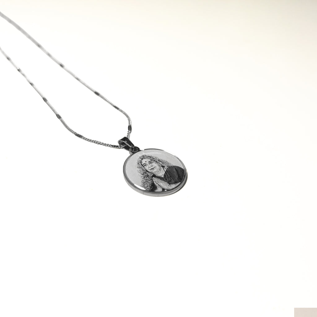 Custom devotional portrait pendant handpainted miniature art stainless steel silver chain 26mm religious jewelry spiritual keepsake detailed brushwork silvery white background heirloom quality wearable meditation piece