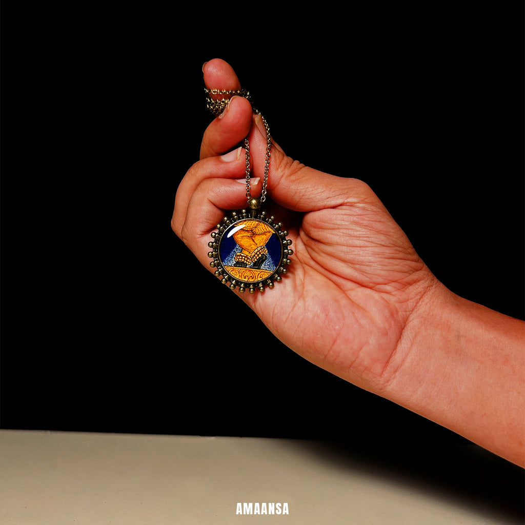 Hand holding a decorative pendant with a colorful design against a black background. Handpainted vintage-style locket Radhavallabh full color miniature painting devotional jewelry god coin antique finish spiritual keepsake religious necklace divine blessing collector piece