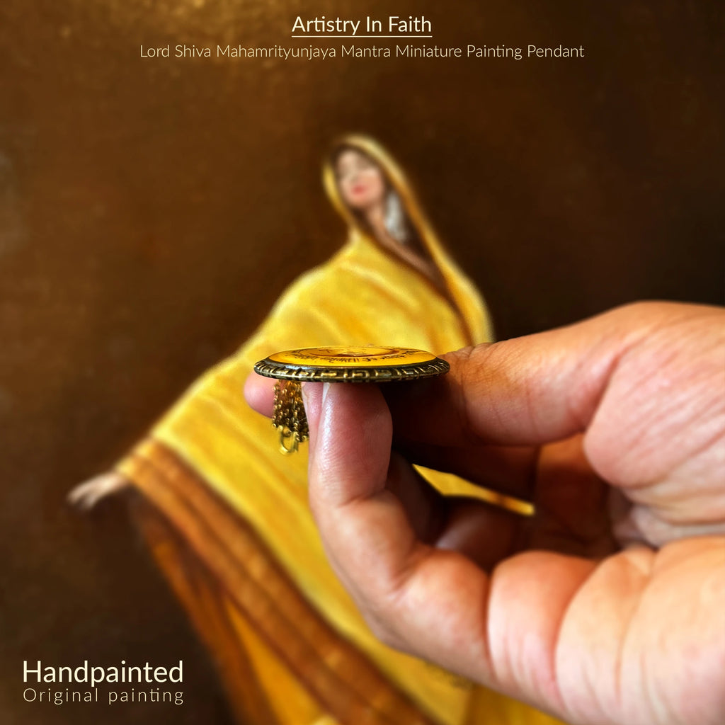 Handheld pendant with Lord Shiva miniature painting, blurred background, horizontal product shot