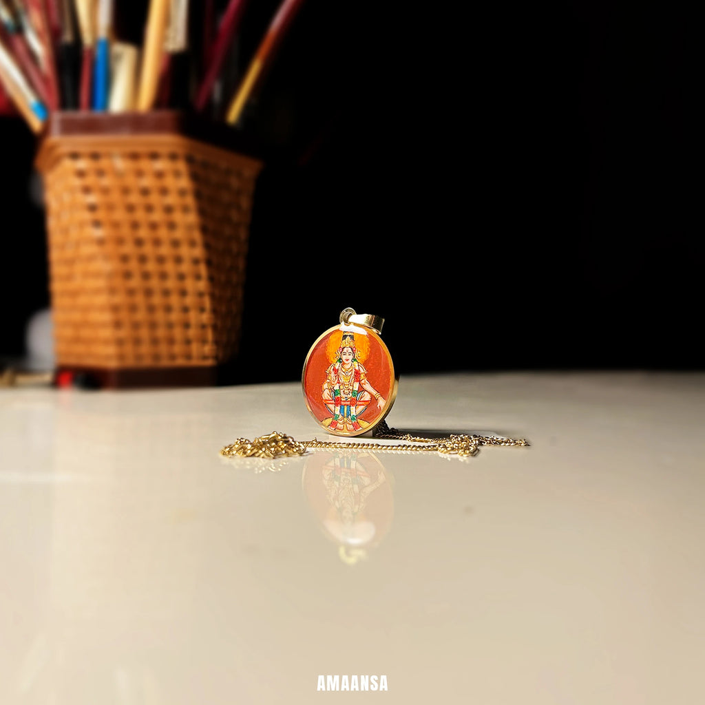 Lord Ayyappa hand‑painted miniature pendant on chain, devotional necklace for Sabarimala devotees on a reflective surface.