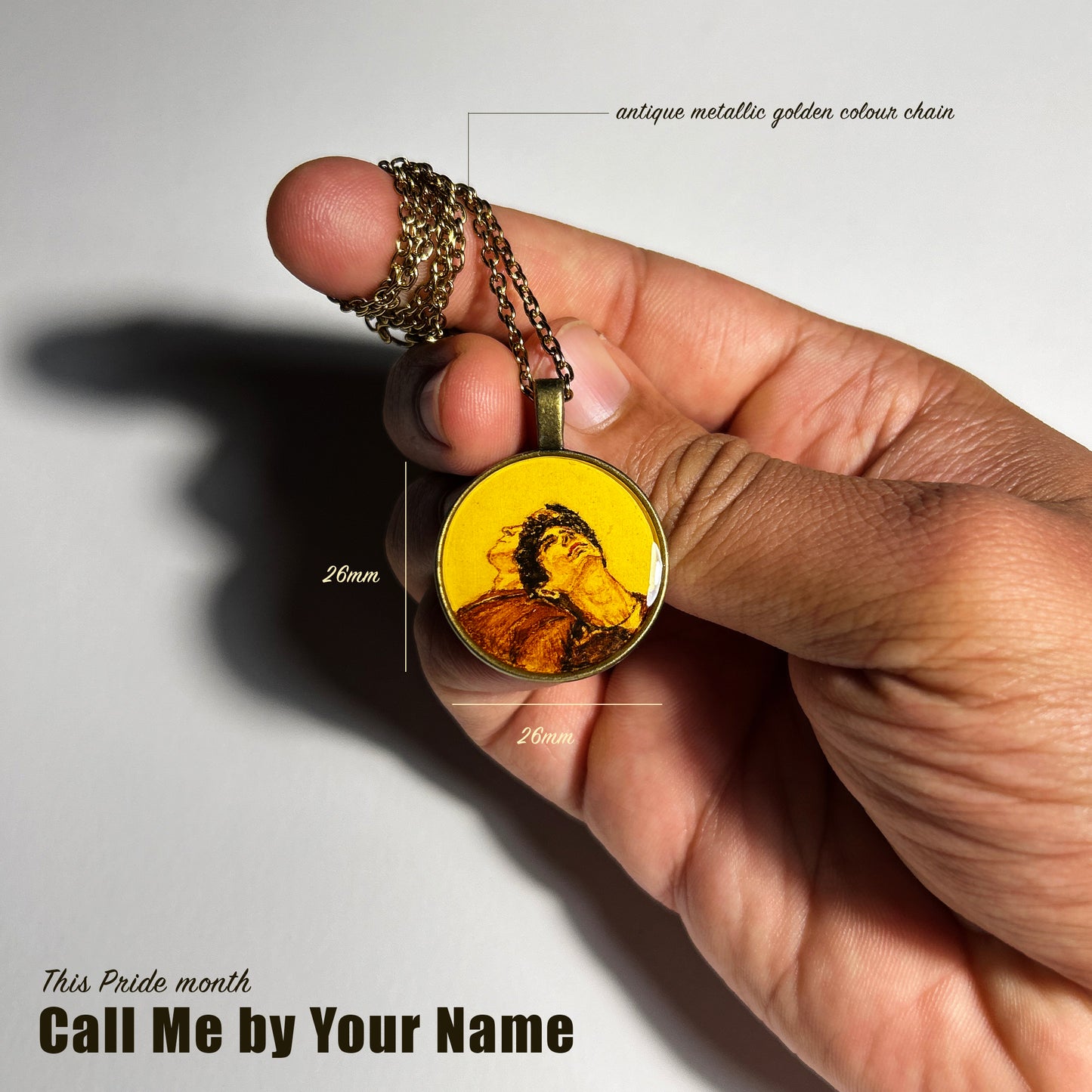 A handpainted pendant from AMAANSA Fine Arts Studio’s Pride Collection, featuring a detailed miniature painting of the movie cover 'Call Me by Your Name.' The vibrant portrait is painted on a circular pendant, representing the themes of love and identity. The pendant is showcased as a tribute to the LGBTQ+ community.