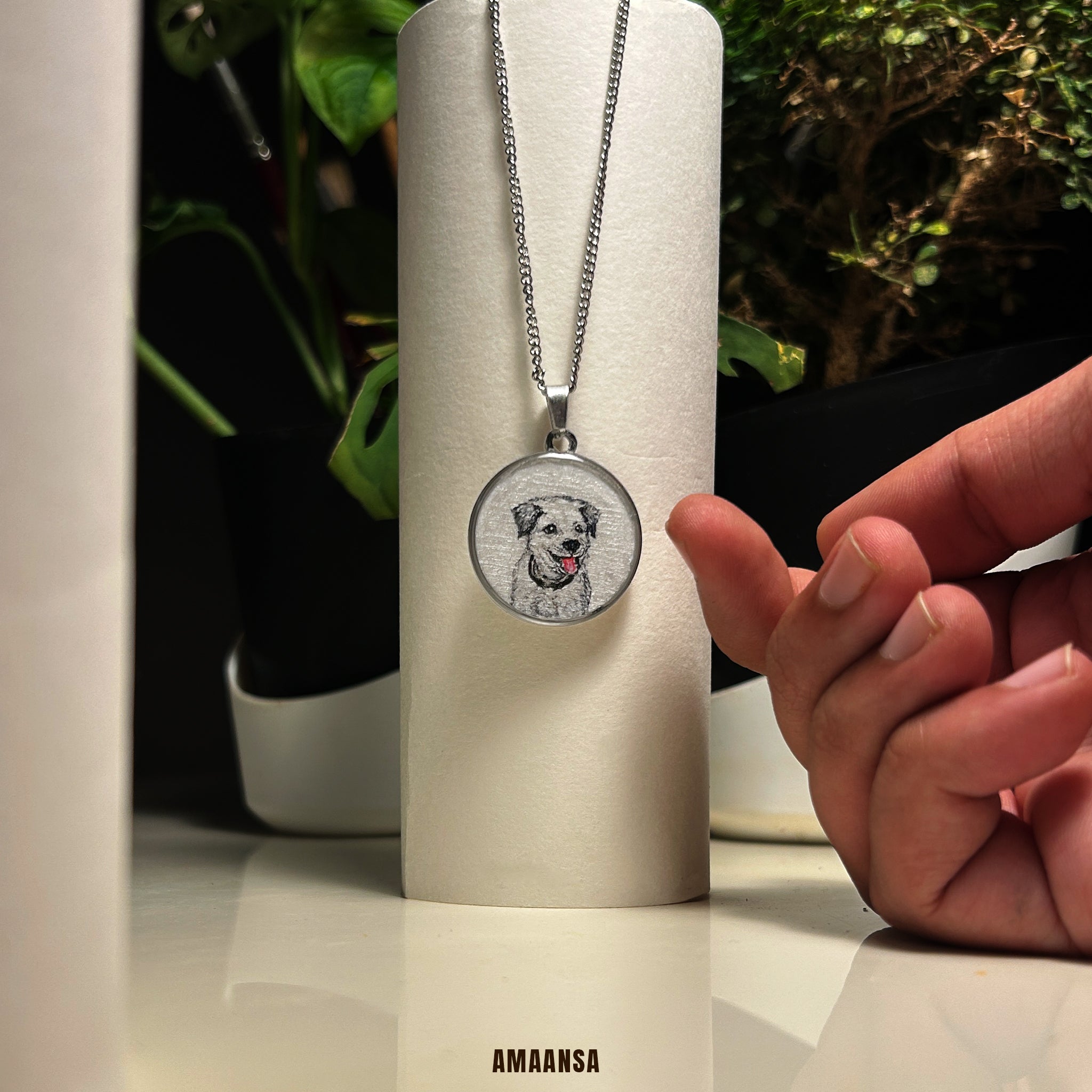 Necklace with a pendant featuring a dog's face on a cylindrical stand, with a hand reaching towards it. Handpainted Border Collie portrait necklace premium silver finish pet memorial jewelry custom dog pendant miniature art pet keepsake personalized tribute commissioned memorial locket furry companion heirloom collectible