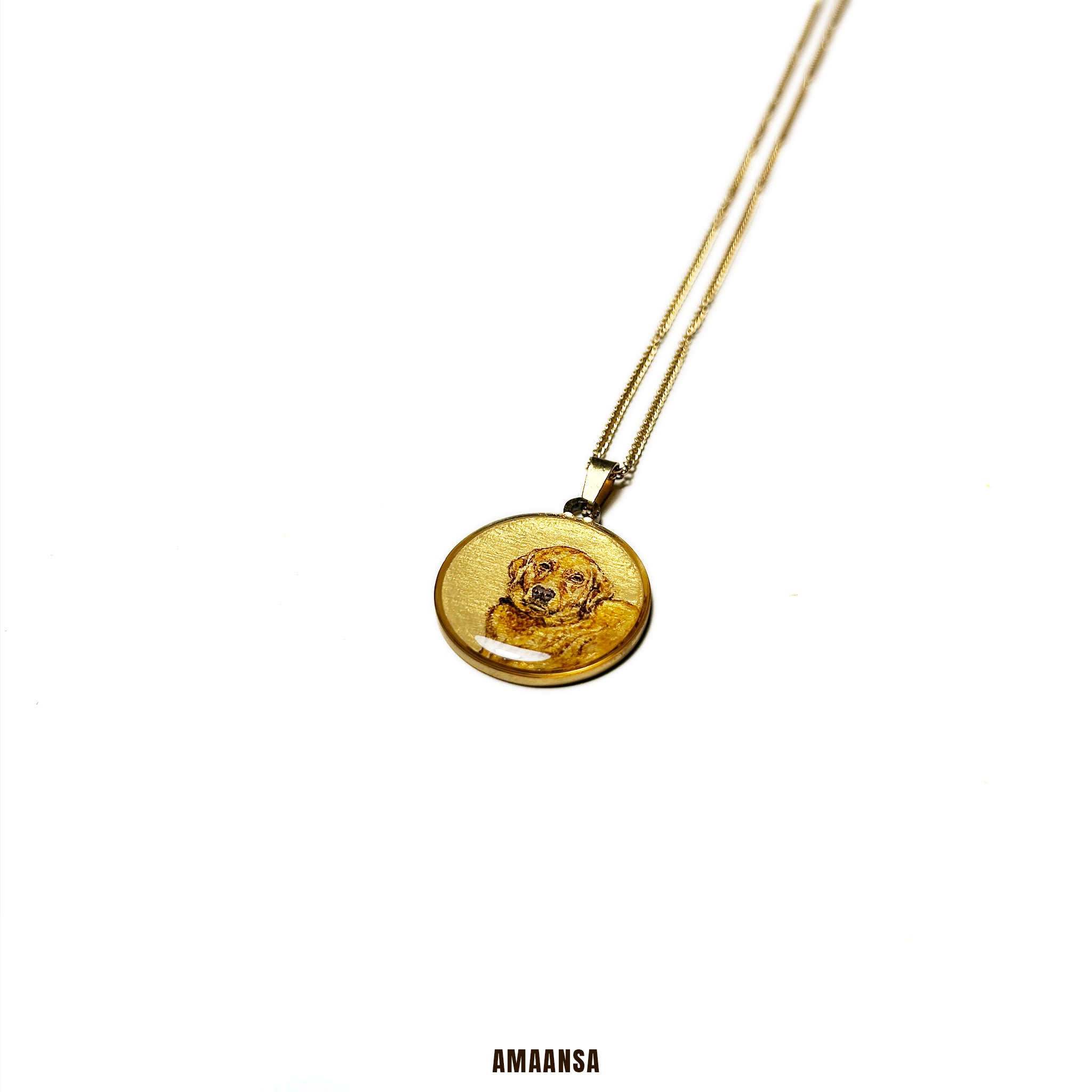 Gold necklace with a round pendant on a white background, branded 'AMAANSA'. Handpainted beloved pet Golden Retriever portrait locket premium 18k gold PVD pet memorial jewelry custom dog pendant miniature art pet keepsake personalized tribute commissioned memorial necklace furry family heirloom collectible