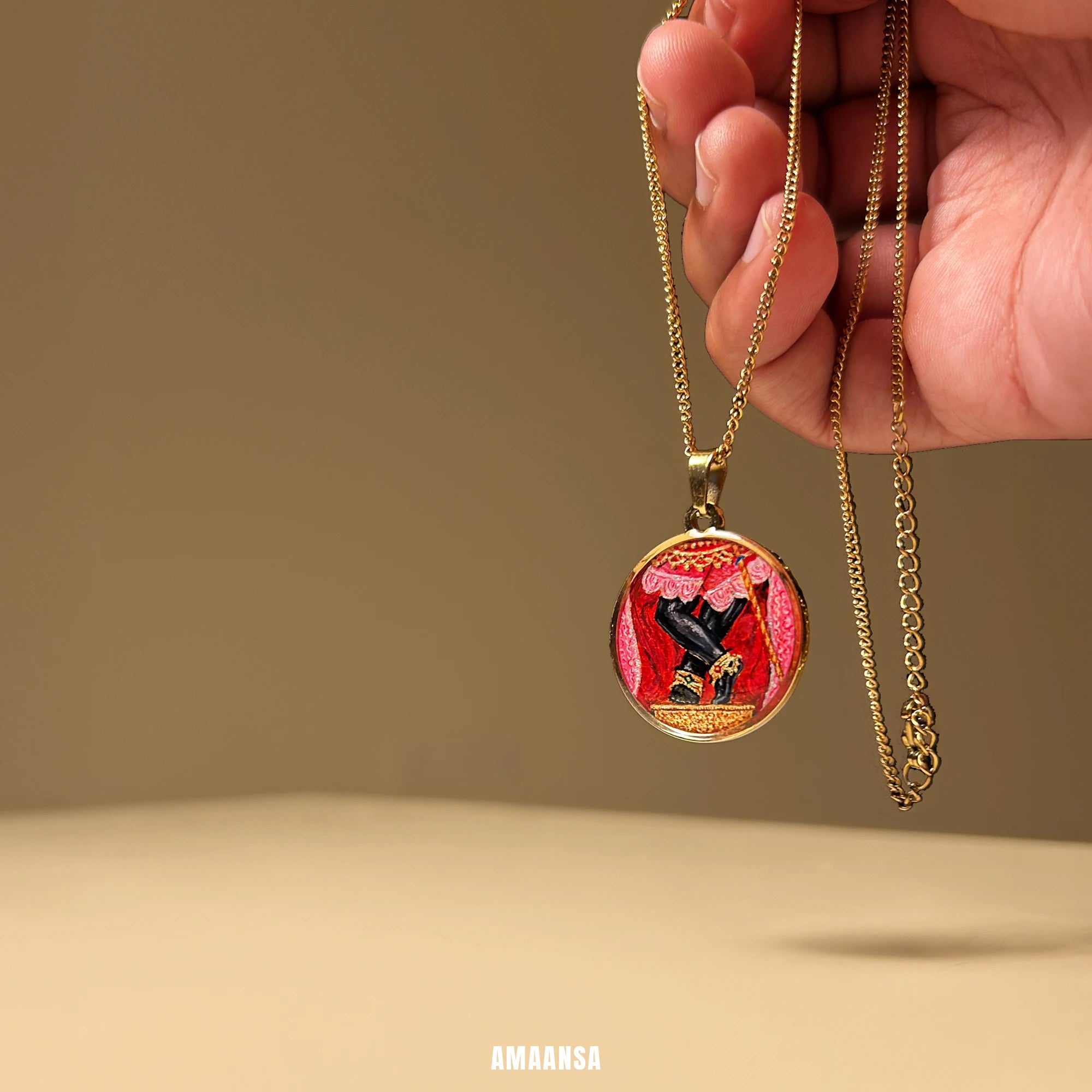 Sri Radharamanji paduka gold‑plated pendant with red shrine curtains, hand‑painted miniature devotional necklace styled for gifting.

