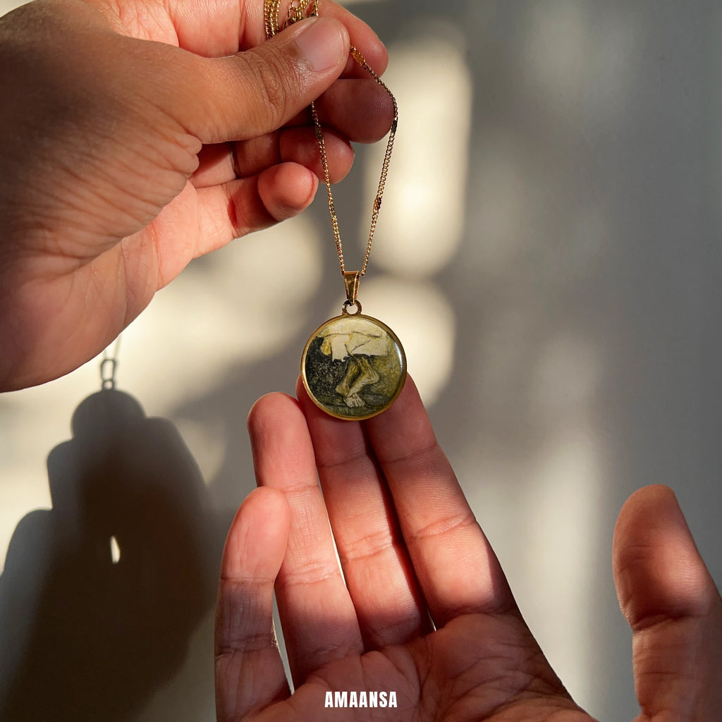 Sai Baba charan 18k gold‑plated pendant on chain in gentle daylight, sacred feet miniature shown as quiet personal devotion piece.