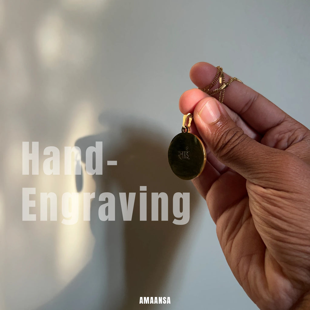 Back of Sai Baba charan 18k gold‑plated pendant showing engraved script, devotional necklace highlighting hand‑engraving detail.