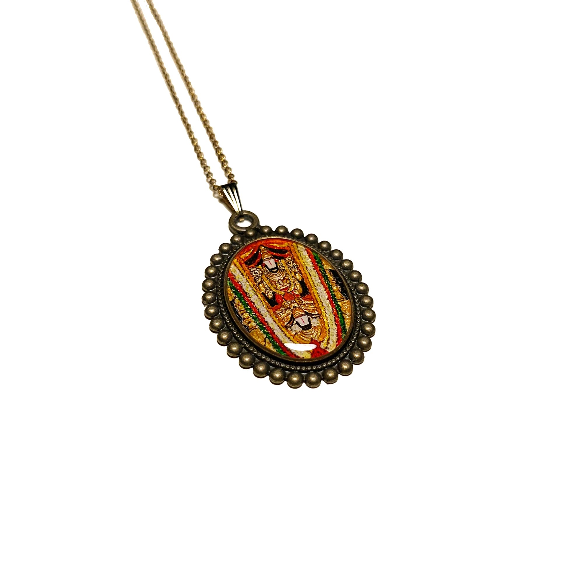 Side view of Venkateswara Swamy antique gold‑tone oval miniature pendant on chain, devotional temple jewelry with soft reflection on surface.
on a white background