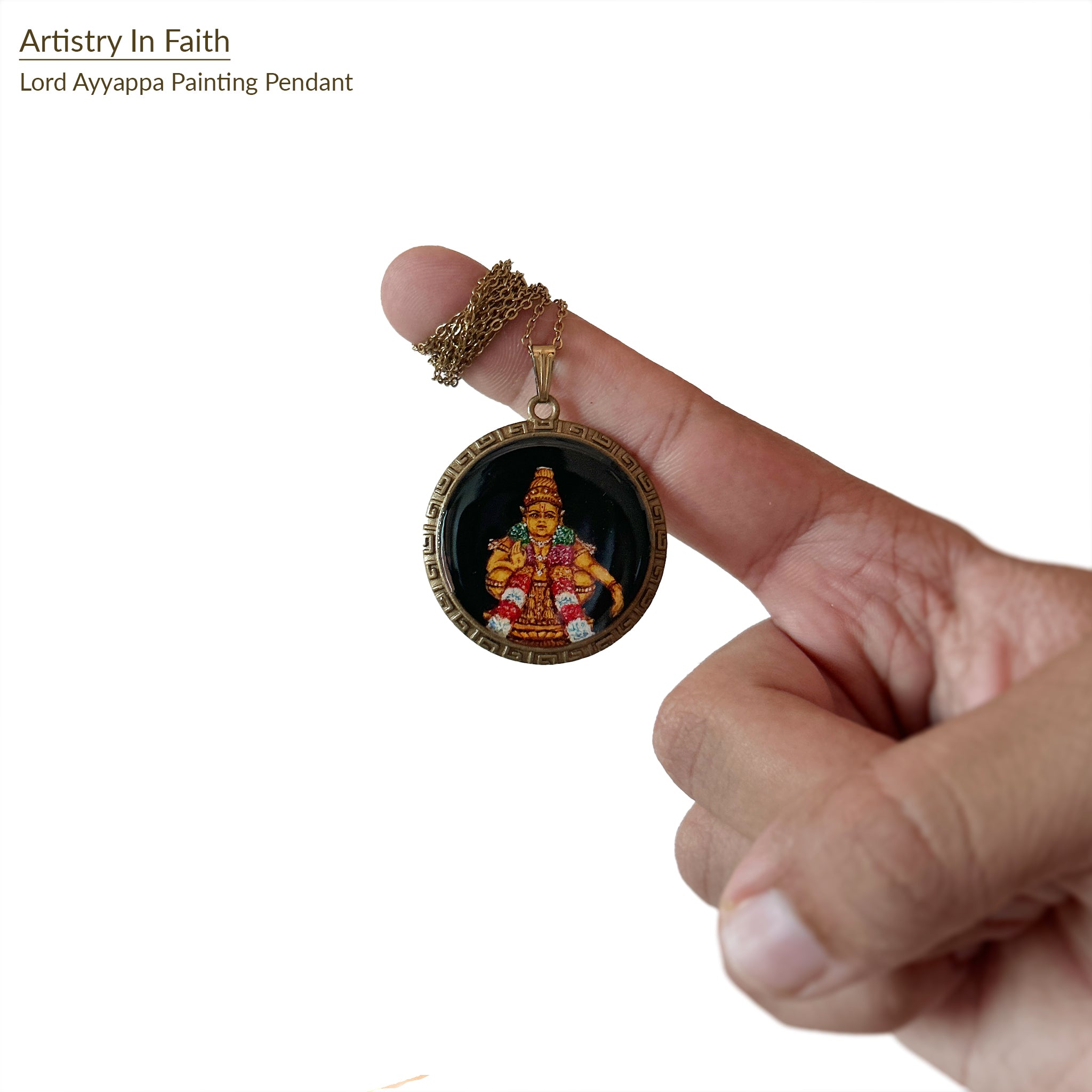 Artistry in Faith Collection - Handcrafted Lord Ayyappa pendant (3.2cm), featuring intricately painted full-body deity in traditional pose with raised hands and crossed legs, adorned with ornate crown and sacred garlands. Vibrant ceremonial attire in rich golds and reds set against mystical black background, framed by vintage-styled metallic border with Greek key pattern. Each brushstroke captures the deity's serene expression, creating meaningful devotional jewelry in antique brass finish