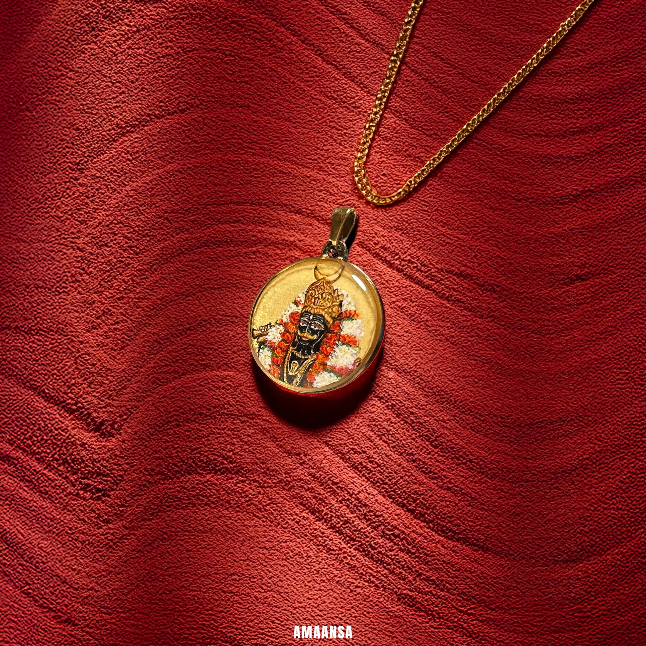  intricate design of Lord Kaal Bhairava 18k gold‑plated round pendant with hand‑painted fierce black‑hued deity and marigold garlands, devotional necklace on a red textured background