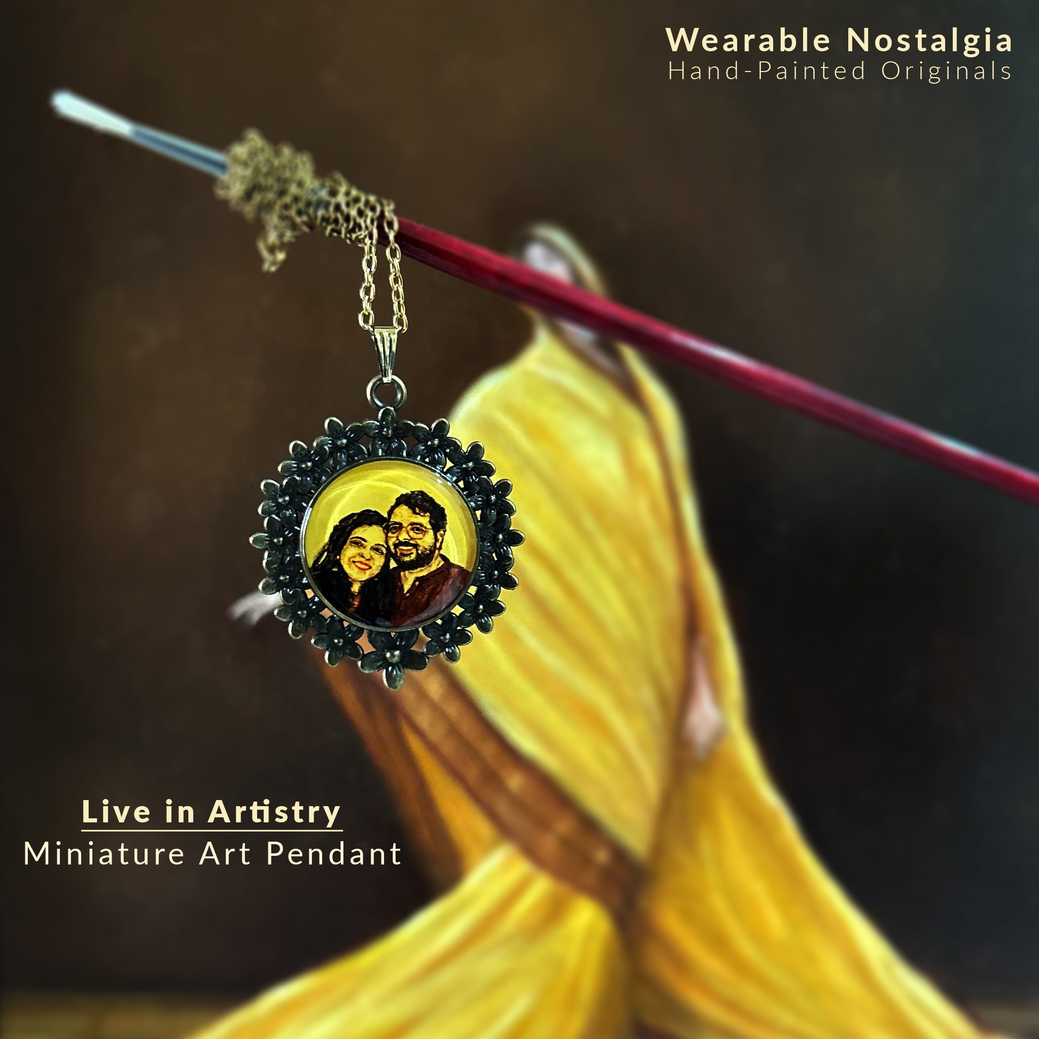 Bespoke miniature art pendant (26mm), eternizing a couple's tender moment with heritage-inspired hues. Wife's gentle smile matches husband's delighted expression, framed by an ornate Vintage Floral Wreath in antique brass finish. Poised delicately on a paint brush with antique gold colored chain, against artist's classical oil portrait. Sealed with museum-grade finish, this jewelry art piece celebrates an art enthusiast's love story.