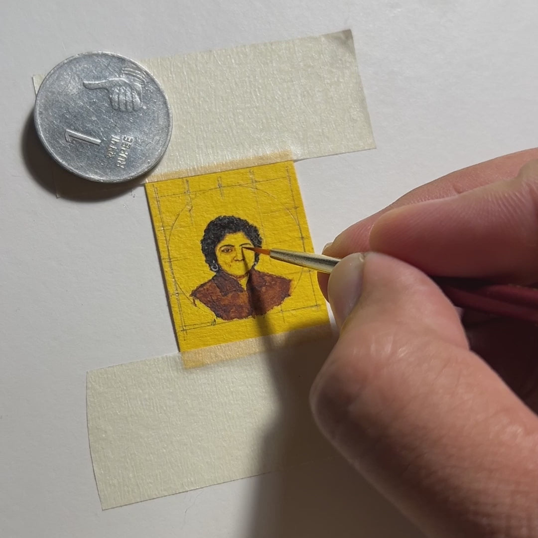 19 sec video, AMAANSA's creative process: Expert artisan revives a 1980s black & white photograph through miniature painting (26mm). The finest brush meticulously details the left eye and curly hair of client's youthful mother, transforming monochrome memory into vibrant artistry. 1-rupee coin provides scale reference, showcasing remarkable detail. Filmed under studio lighting, this 19-second glimpse reveals how we preserve vintage moments. Enhanced with ambient music.