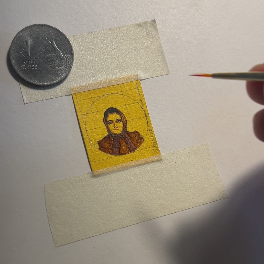 Behind-the-scenes at AMAANSA studio: Watch as artisan breathes color into a 1970s black & white photograph through miniature painting (26mm). The finest brush delicately details the youthful lips of client's mother, transforming monochrome memories into vibrant artistry. 1-rupee coin provides scale reference, showcasing the remarkable detail achieved at this size. Filmed against white backdrop under studio lighting, this 18-second glimpse reveals how we preserve vintage moments. Enhanced with ambient music.