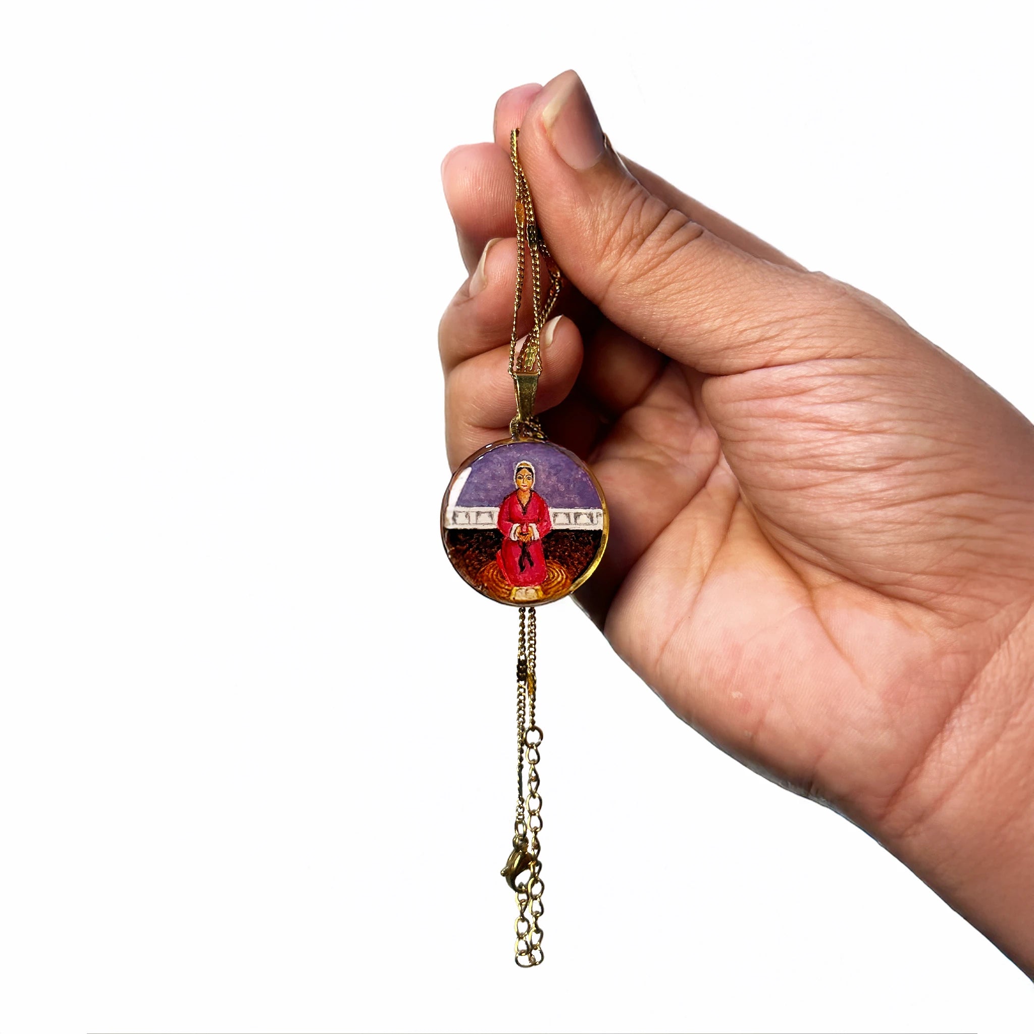 Close‑up of hand holding 18k gold‑plated Mata Rupa Bhawani miniature pendant, spiritual necklace shown as thoughtful devotional gift.