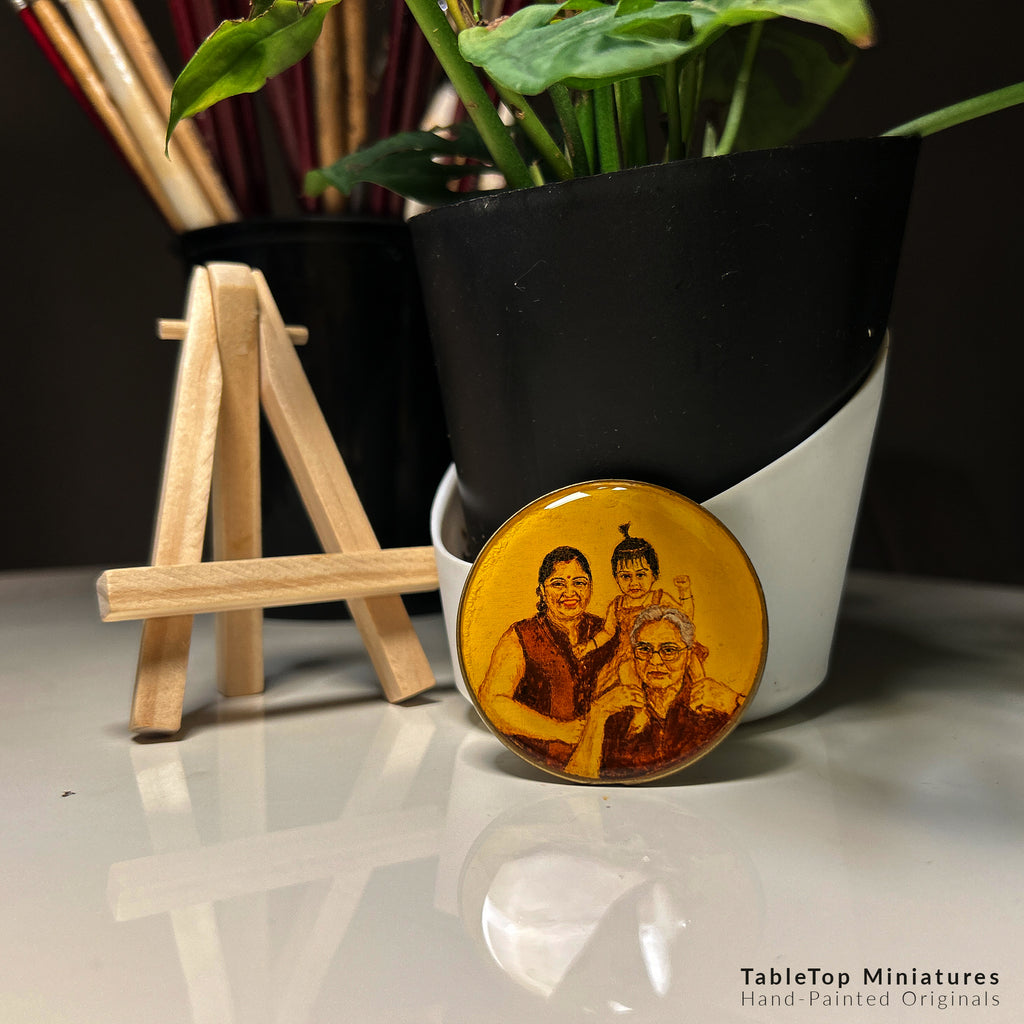 Hand-painted miniature (5cm) capturing three-generation bond: grandfather with gentle smile and glasses, daughter's warm expression beside him, and playful granddaughter perched on his shoulders with a tiny topknot, painted in rich brown and burnt umber on naples yellow background. Artwork displayed with wooden easel against modern black-white planter with monstera leaves, showing how this vintage-styled, heirloom-quality piece preserves precious family moments.
