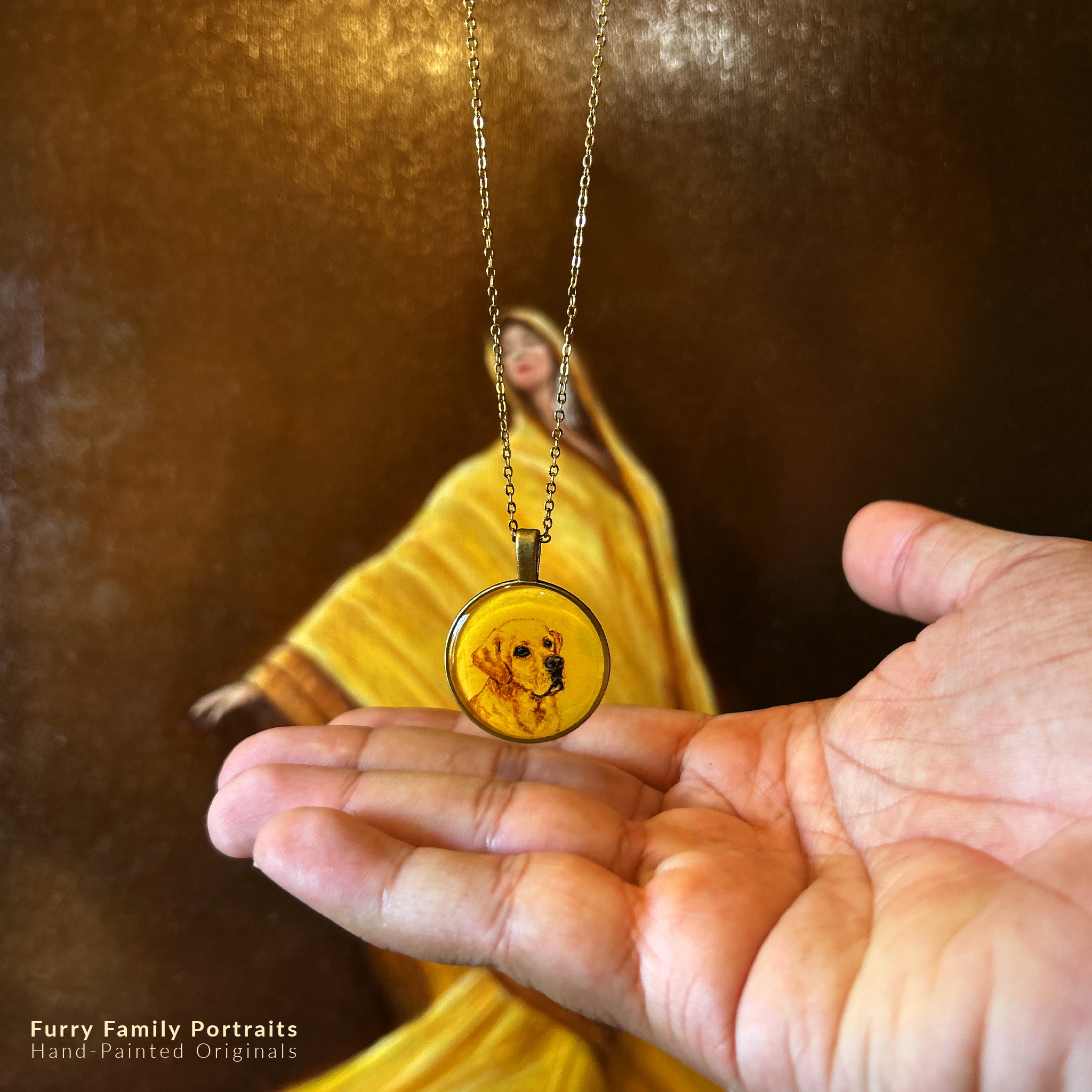 Bespoke miniature pendant (2.6cm) featuring faithful Labrador's gentle portrait, capturing those soulful eyes and characteristic soft expression in warm sepia tones on naples yellow background. Classic round frame with crystal-clear sealant floats above open palm, delicate chain suspended against artist's original oil painting with flowing golden drapery, creating heirloom-quality memorial piece that preserves cherished companion's loving spirit.
