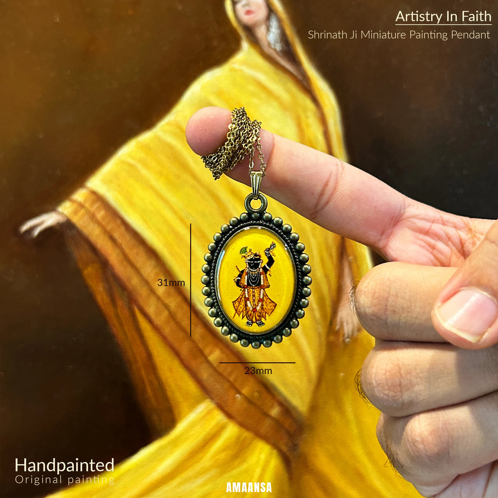 Hand‑painted Shrinathji miniature pendant hanging freely, temple‑inspired devotional jewelry shot.